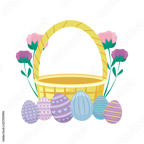 basket wicker with eggs of easter and flowers