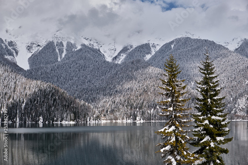 Beautiful mountain Lake Ritsa. Lake Ritsa in the Caucasus Mountains, in the north-western part of Abkhazia, Georgia, surrounded by mixed mountain forests and subalpine meadows. Snow in mountains © Ivan_vislov_nadsochi