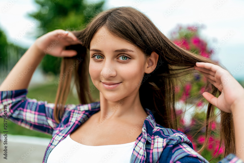 Portrait of cute twelve year old girl in the park. Stock Photo