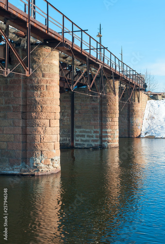 Kommunar dam, a pedestrian bridge over the Miass river photo