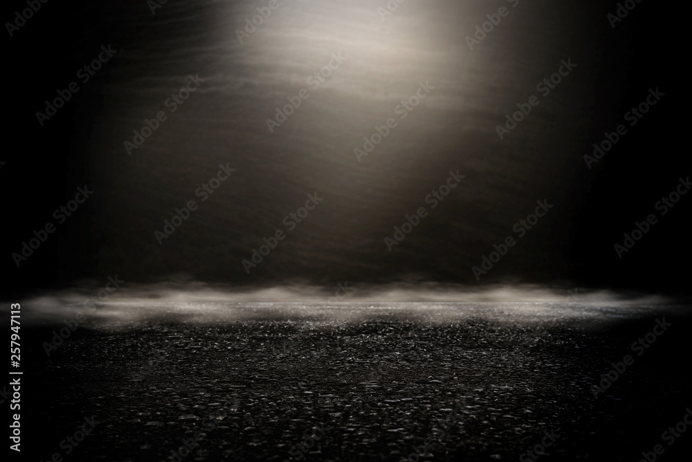 Spotlight over concrete floor. dark black background Spotlight over concrete floor. dark black background