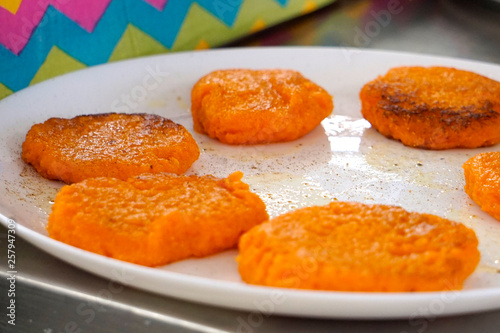  fried carrot fritters on a plate 