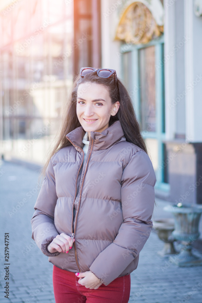 Portrait of a beautiful girl with dark hair in city street Portrait of a beautiful girl with dark hair in city street