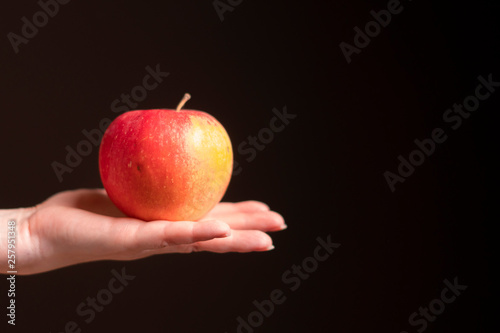 red apple on girl's hand