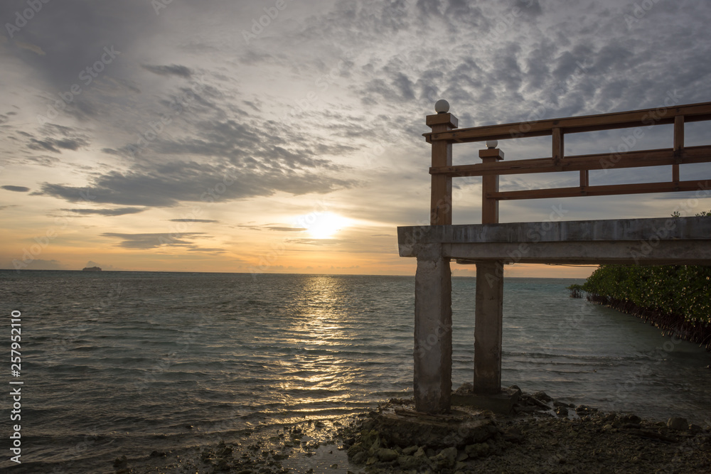 The stone bridge that located at sunset point on Royal Island, Indonesia. A great place to sit and enjoy the beauty of sunset