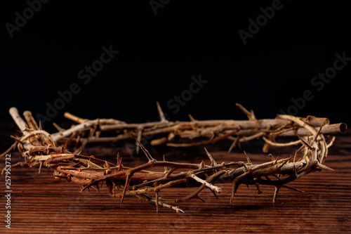 Christianity, the resurrection and suffering of Jesus Christ concept theme with a crown of thorns isolated on wood background with copy space