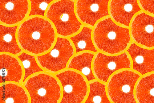 Pattern made from fresh grapefruit slices on a white background, overhead view, flatlay. Fruit background.