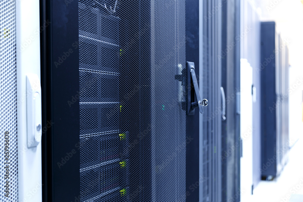 concept of access to computing and storage of information , handle with a lock and a key in it on the server door in the modern data center. depth of field, blur concept of access to computing and storage of information , handle with a lock and a key in it on the server door in the modern data center. depth of field, blur