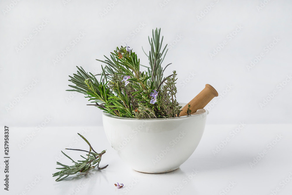 Aromatic plant: lavender, rosemary, thyme in the white ceramic mortar with pestle on white background