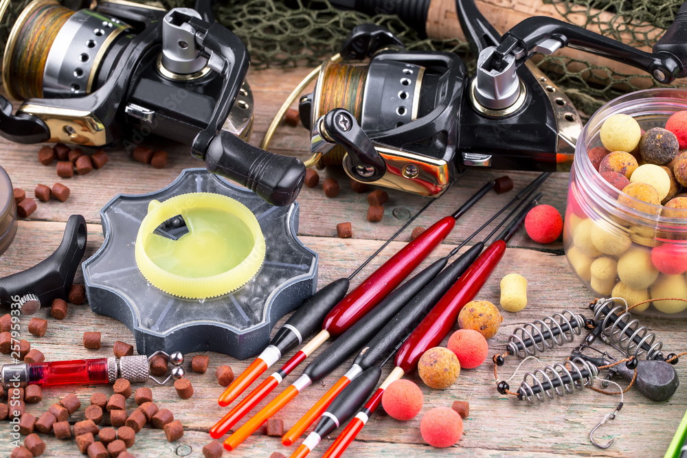 fishing tackle on a wooden table. toned image fishing tackle on a wooden table. toned image