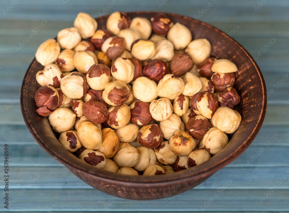 Healthy food for background image close up hazelnuts. Nuts texture on top view on the cup plate Healthy food for background image close up hazelnuts. Nuts texture on top view on the cup plate