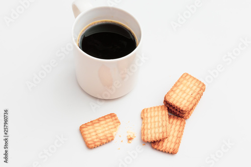 Cup of coffee and biscuit on table Flat lay