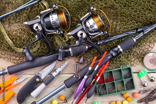 fishing tackle on a wooden table. toned image 