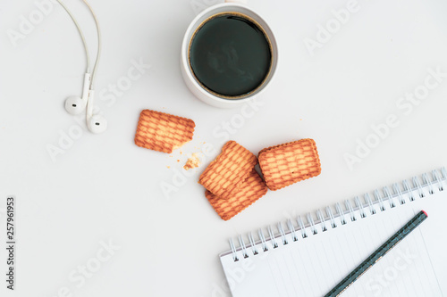 Cup of coffee and biscuit on table Flat lay