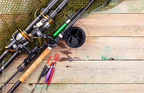 fishing tackle on a wooden table. toned image 