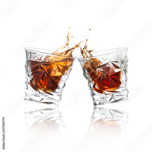 Εκτύπωση καμβά Glasses of expensive whiskey clinking together and splashing on white background