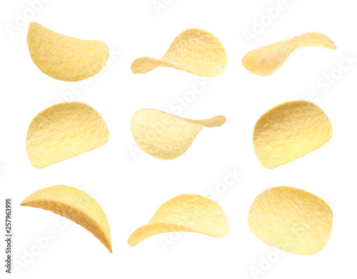 Set of fried crispy potato chips on white background