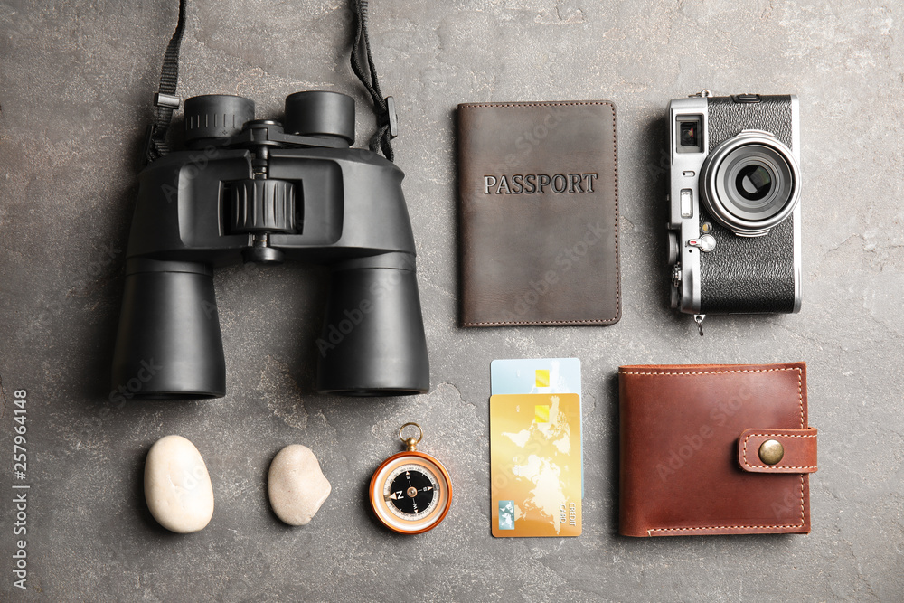Flat lay composition with tourist items on grey background. Travel agency Flat lay composition with tourist items on grey background. Travel agency