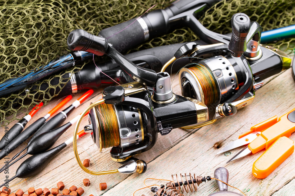 fishing tackle on a wooden table. toned image fishing tackle on a wooden table. toned image