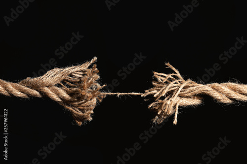Rupture of cotton rope on black background