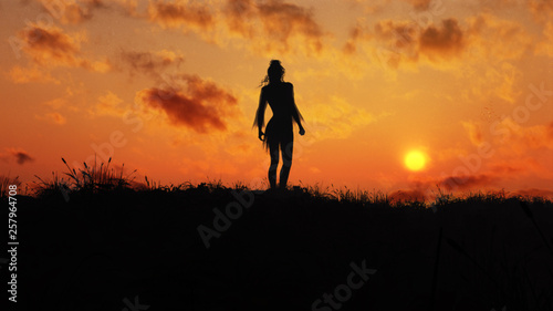 silhouette of a woman in epic sunset on top of a hill