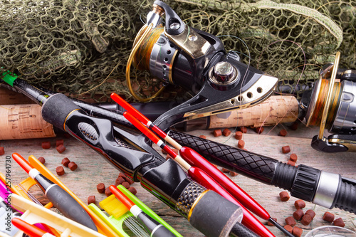 fishing tackle on a wooden table. toned image 