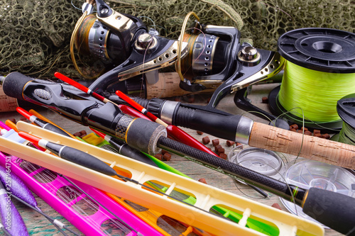 fishing tackle on a wooden table. toned image 