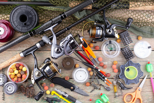 fishing tackle on a wooden table. toned image 