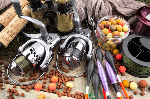 fishing tackle on a wooden table. toned image 