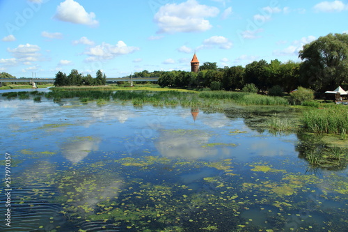 Clouds and an ancient tower reflected in a quiet river © hlam70
