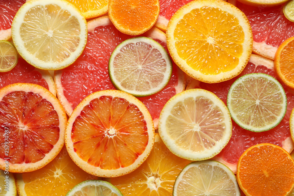 Slices of fresh citrus fruits as background, top view Slices of fresh citrus fruits as background, top view