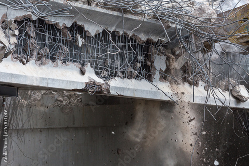 Obraz na plátne Professional demolition of reinforced concrete structures using industrial hydraulic hammer