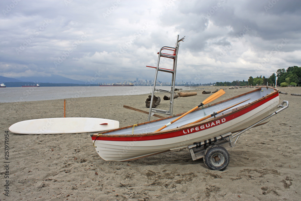 Lifeguard Paddle board and dinghy, on Jericho Beach, Vancouver Lifeguard Paddle board and dinghy, on Jericho Beach, Vancouver