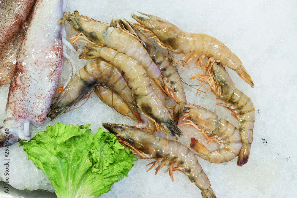 Fresh chilled seafood shrimp and octopus on ice at the fish market counter. Fresh chilled seafood shrimp and octopus on ice at the fish market counter.