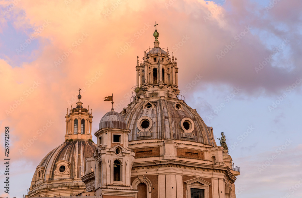Sunset Domes - A close-up sunset view of the domes of Santa Maria di Loreto, right, and the Most Holy Name of Mary at the Trajan Forum, left, against colorful clouds and blue sky. Rome, Italy.