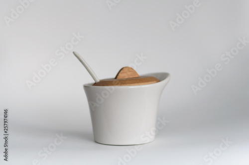 Modern White Sugar Bowl With A Spoon And A Wooden Lid