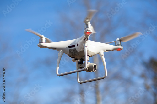 Flying drone with blue sky background, technology