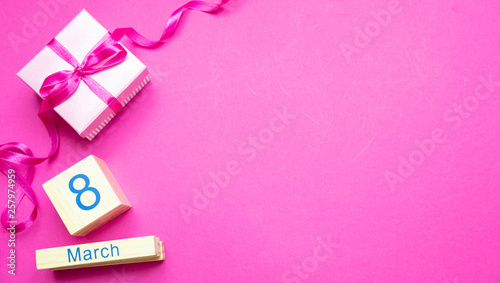 Gift box with ribbon and Womens day March 8th on pink background