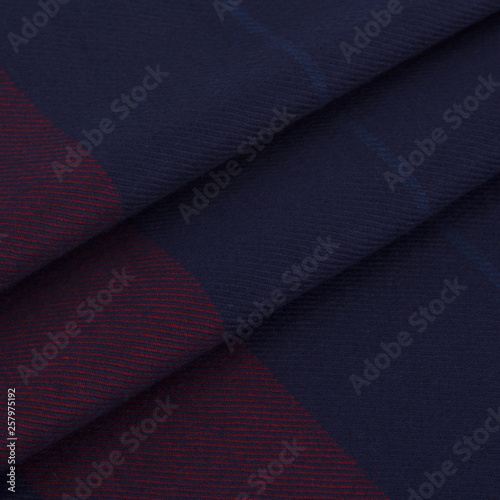 Close-up men's scarf in dark blue and red with light blue checkered fabric with folds