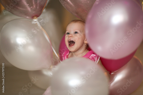 Happy baby princess with white and pink balloons