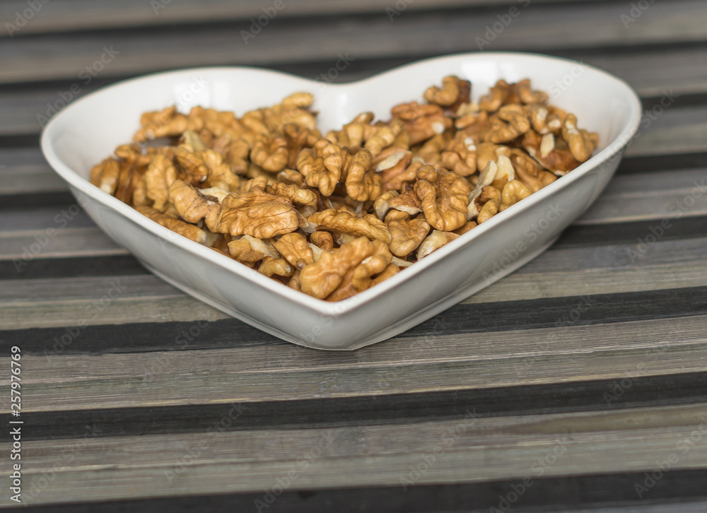 Nuts arranged in heart on background. Healthy Food image close up walnuts nuts. Love Texture Nuts arranged in heart on background. Healthy Food image close up walnuts nuts. Love Texture