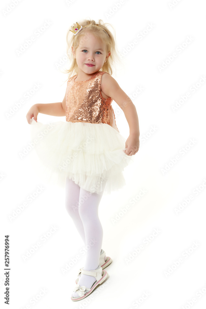 A little girl is photographed in the studio on a cyclorame. A little girl is photographed in the studio on a cyclorame.