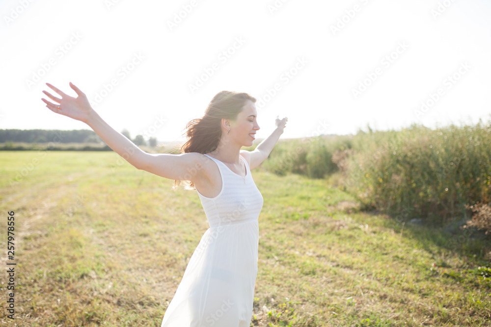 Beautiful caucasian girl walking on the field. Summer time day Beautiful caucasian girl walking on the field. Summer time day