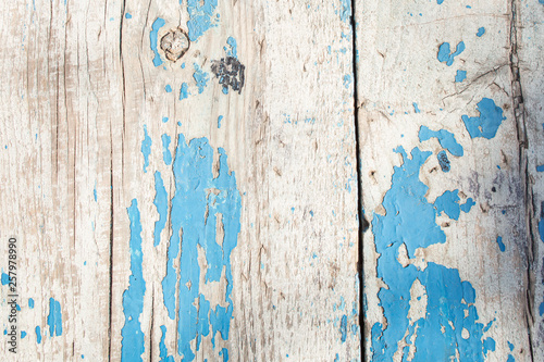 cracked horizontal wooden panel with peeling blue paint