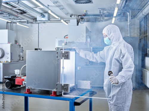 Chemist working in industrial laboratory clean room