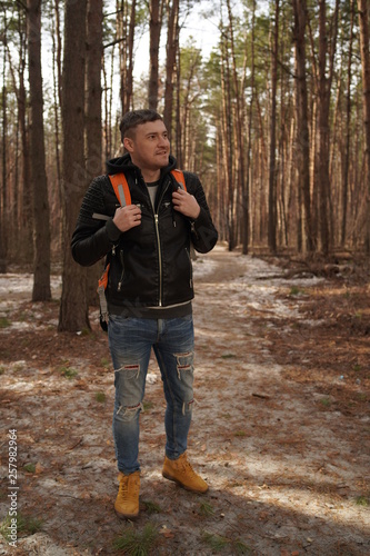 Traveler Man with backpack hiking Travel Lifestyle concept.  The traveler goes through the forest © Anton Dios