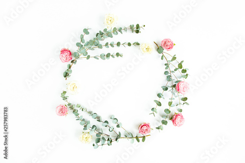 Round wreath frame eucalyptus branches and rose flowers isolated on white background. Flat lay, top view.  Floral frame. Wreath of flowers.
