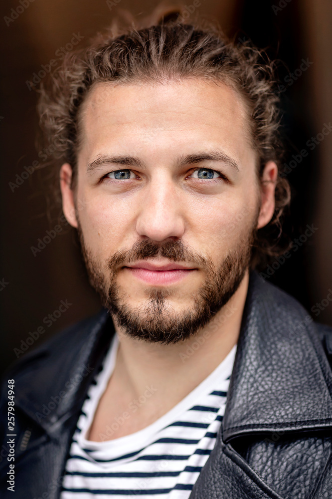 Portrait of a young man with a man bun Portrait of a young man with a man bun