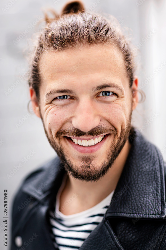 Portrait of a young man with a man bun Portrait of a young man with a man bun