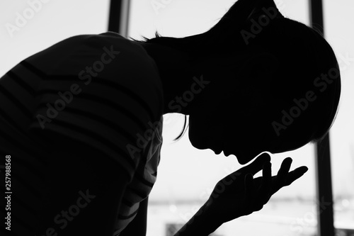 silhouette of young woman feeling tired and stressed photo